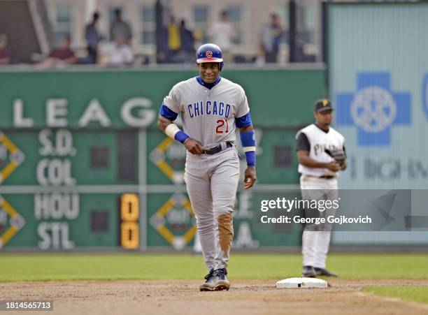 Sammy Sosa of the Chicago Cubs smiles as he looks on from the field after batting against the Pittsburgh Pirates as second baseman Abraham Nunez of...