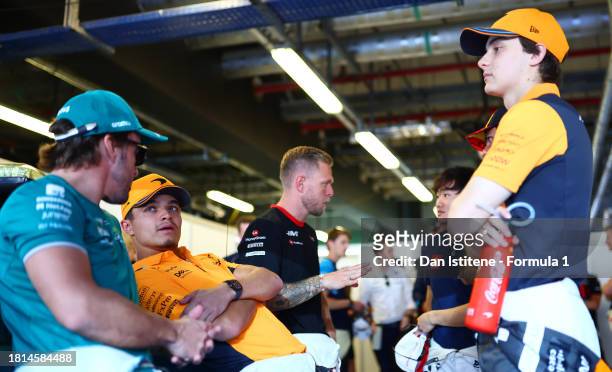 Lando Norris of Great Britain and McLaren, Fernando Alonso of Spain and Aston Martin F1 Team and Oscar Piastri of Australia and McLaren talk on the...