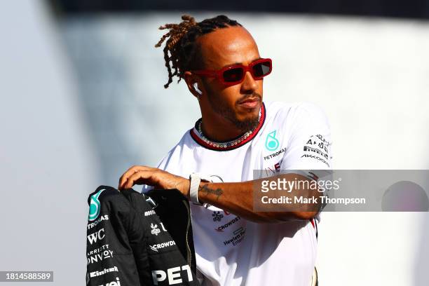 Lewis Hamilton of Great Britain and Mercedes looks on from the drivers parade prior to the F1 Grand Prix of Abu Dhabi at Yas Marina Circuit on...