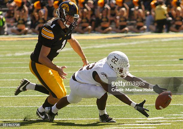 Running back Dareyon Chance of the Western Michigan Broncos recovers a fumble during the fourth quarter in front of place kicker Marshall Koehn of...