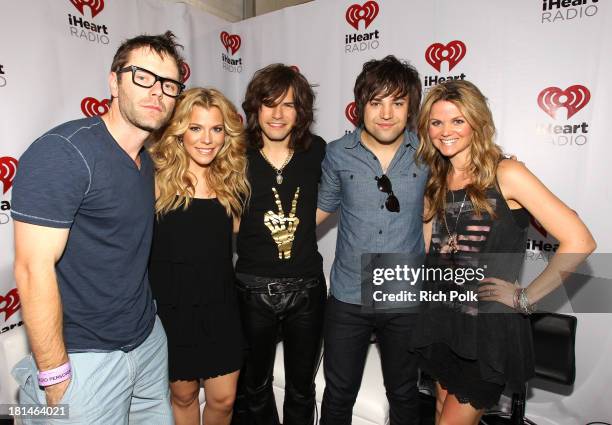 Radio personalities Bobby Bones and Amy Brown pose with Kimberly Perry, Reid Perry and Neil Perry of The Band Perry during the iHeartRadio Music...