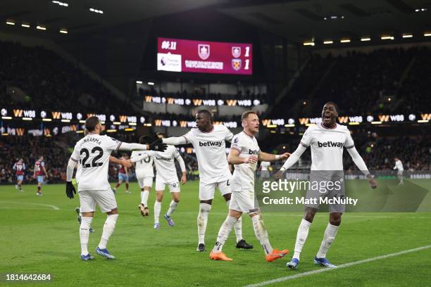 Divin Mubama of West Ham United celebrates with teammates after scoring the teams first goal during the Premier League match between Burnley FC and...