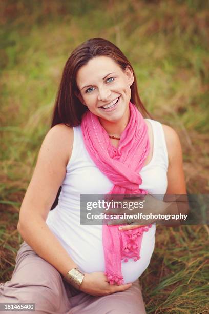 maternity portrait of a woman in a pink scarf - brown hair blue eyes and dimples stock pictures, royalty-free photos & images