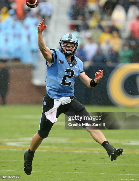 Quarterback Bryn Renner of the North Carolina Tar Heels scrambles and throws a pass during the game against the Georgia Tech Yellow Jackets at Bobby...