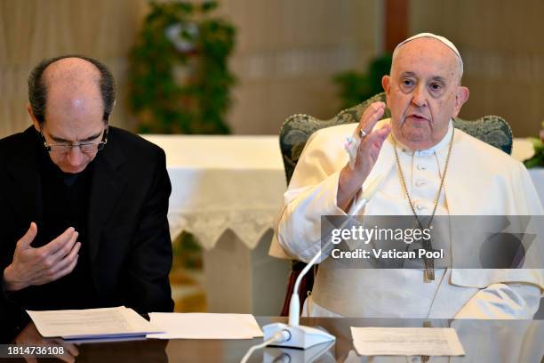 Pope Francis, flanked by Msgr. Paolo Braida delivers his Sunday Angelus blessing from his residence at the Casa Santa Marta on November 26, 2023 in...