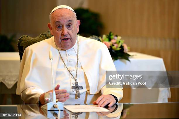 Pope Francis, flanked by Msgr. Paolo Braida delivers his Sunday Angelus blessing from his residence at the Casa Santa Marta on November 26, 2023 in...