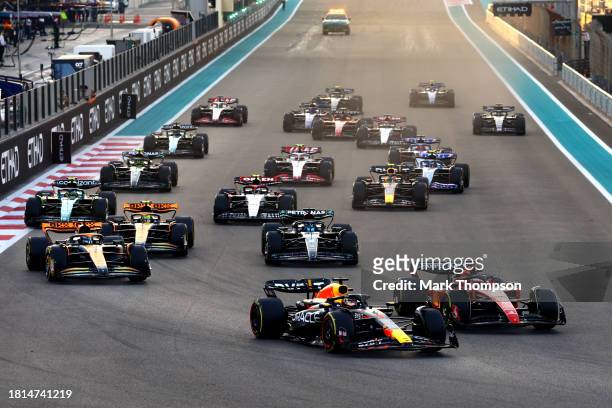 Max Verstappen of the Netherlands driving the Oracle Red Bull Racing RB19 leads the field into turn one at the start during the F1 Grand Prix of Abu...