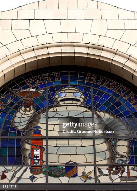 The Michelin Man logo is shown on the front of the Michelin headquarters February 25, 2003 in London. The French tire maker announced that its net...