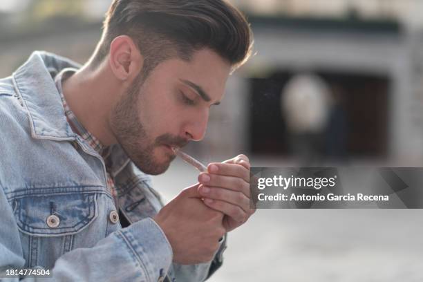smoking young man cigar in the city - 20 cigarette stock pictures, royalty-free photos & images