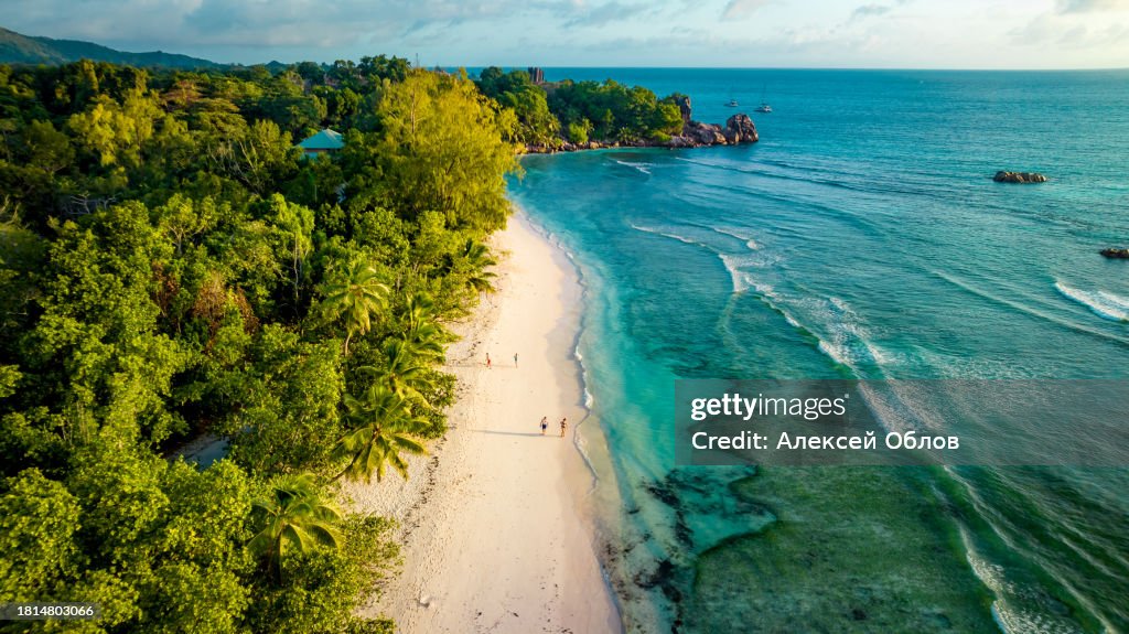 Aerial view Top down seashore. Beautiful azure sea surface in sunny day summer background Amazing seascape top view seacoast at Anse Severe Beach, La Digue Seychelles