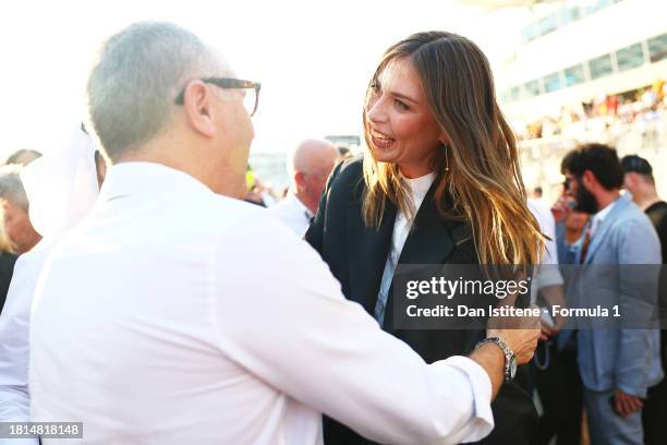 Stefano Domenicali, CEO of the Formula One Group, greets Maria Sharapova on the grid prior to the F1 Grand Prix of Abu Dhabi at Yas Marina Circuit on...