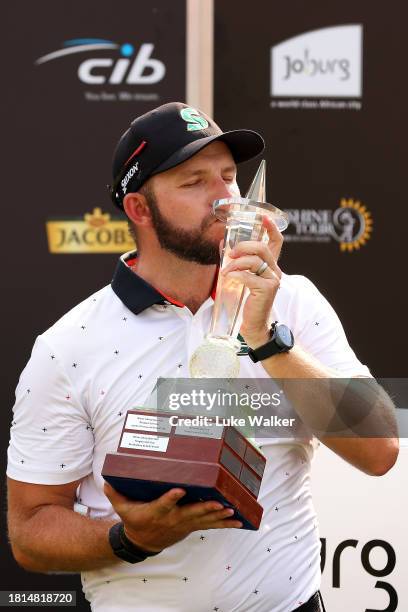 Dean Bermester of South Africa celebrates with the trophy after winning during Day Four of the Joburg Open at Houghton GC on November 26, 2023 in...