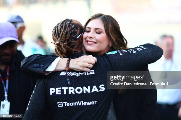 Lewis Hamilton of Great Britain and Mercedes greets Maria Sharapova on the grid prior to the F1 Grand Prix of Abu Dhabi at Yas Marina Circuit on...