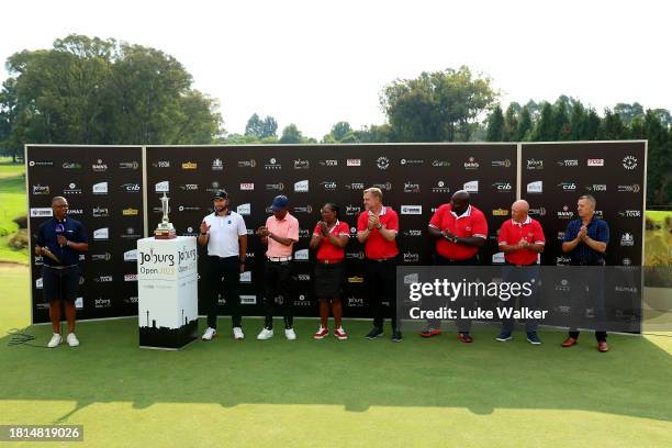 Dean Bermester of South Africa is awarded the trophy on the 18th green after winning during Day Four of the Joburg Open at Houghton GC on November...