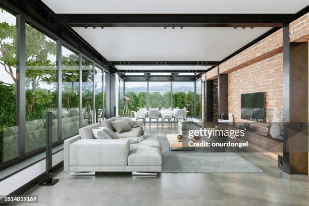 intérieur de villa moderne avec canapé d’angle, table à manger, télévision lcd, mur de briques et paysage de la nature à travers la fenêtre - loft brique photos et images de collection