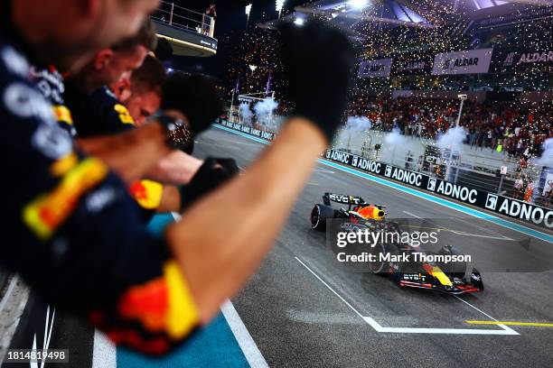 Race winner Max Verstappen of the Netherlands driving the Oracle Red Bull Racing RB19 takes the chequered flag during the F1 Grand Prix of Abu Dhabi...