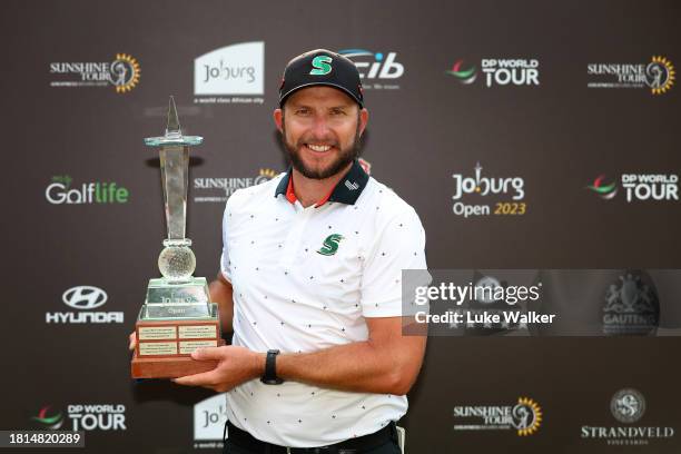 Dean Bermester of South Africa celebrates with the trophy after winning during Day Four of the Joburg Open at Houghton GC on November 26, 2023 in...