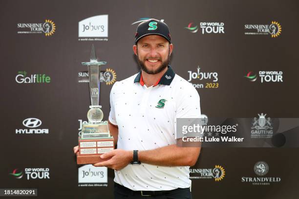 Dean Bermester of South Africa celebrates with the trophy after winning during Day Four of the Joburg Open at Houghton GC on November 26, 2023 in...