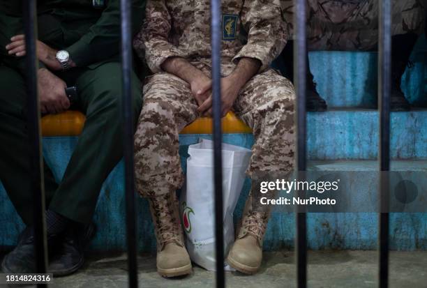 Two members of the Islamic Revolutionary Guard Corps are participating in a ceremony marking Iranian-Sunni female martyrs in Bandar Turkmen, a...