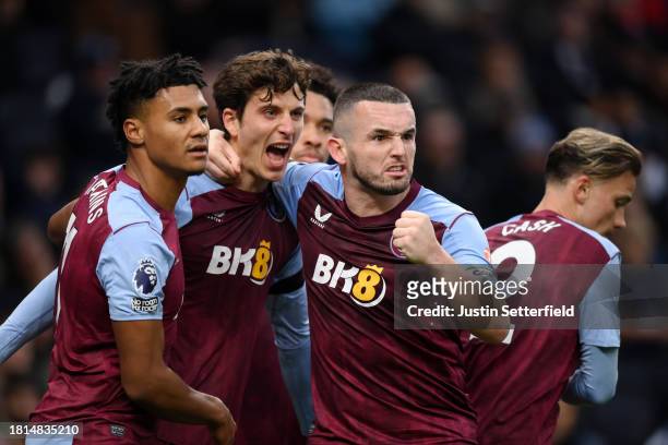 Pau Torres of Aston Villa celebrates with Ollie Watkins and John McGinn of Aston Villa after scoring the team's first goal to equalise during the...
