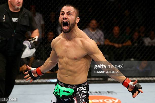 John Makdessi celebrates after knocking out Renee Forte in their UFC lightweight bout at the Air Canada Center on September 21, 2013 in Toronto,...