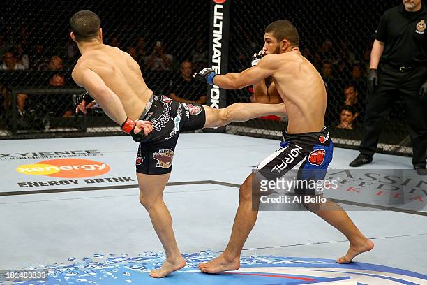 John Makdessi kicks Renee Forte in their UFC lightweight bout at the Air Canada Center on September 21, 2013 in Toronto, Ontario, Canada.