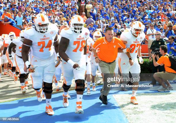 Coach Butch Jones of the Tennessee Volunteers leads the team to the field before play against the Florida Gators September 21, 2013 at Ben Hill...