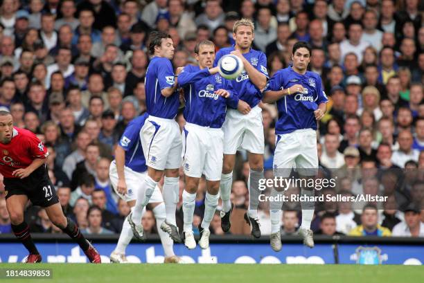 August 13: Simon Davies, Phil Neville, James Beattie, Mikel Arteta of Everton FC jump in wall during the Premier League match between Everton and...