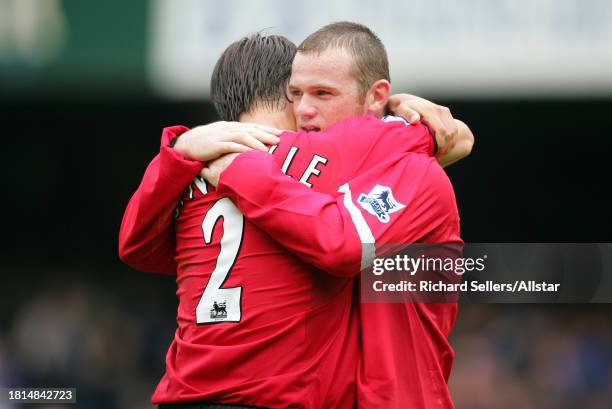 August 13: Wayne Rooney & Gary Neville celebrate during the Premier League match between Everton and Manchester United at the Goodison Park on August...