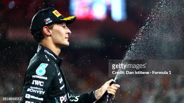 Third placed George Russell of Great Britain and Mercedes celebrates on the podium during the F1 Grand Prix of Abu Dhabi at Yas Marina Circuit on...