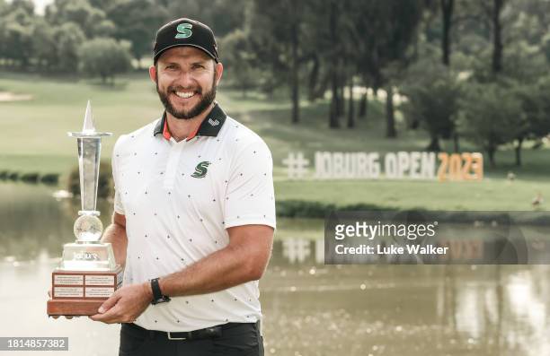 Dean Bermester of South Africa poses with the trophy in the locker room after winning during Day Four of the Joburg Open at Houghton GC on November...