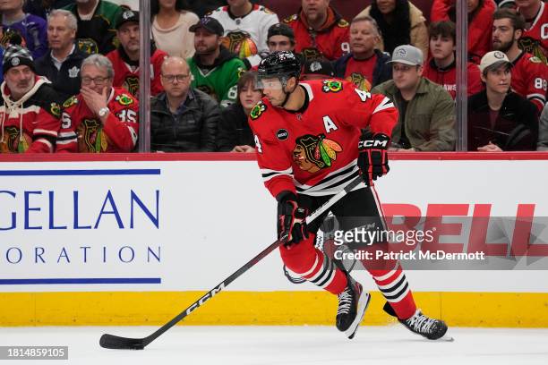 Seth Jones of the Chicago Blackhawks skates with the puck against the Toronto Maple Leafs during the third period at the United Center on November...