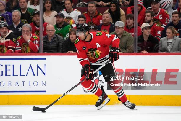 Seth Jones of the Chicago Blackhawks skates with the puck against the Toronto Maple Leafs during the third period at the United Center on November...