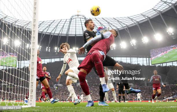 Emiliano Martinez and Ezri Konsa of Aston Villa collide during the Premier League match between Tottenham Hotspur and Aston Villa at Tottenham...