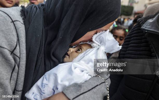 Dead body of a 5-month-old Palestinian baby named Muhammad Hani Al-Zahar, is brought to the Al-Aqsa Martyrs Hospital by his mother Asmahan Attia...
