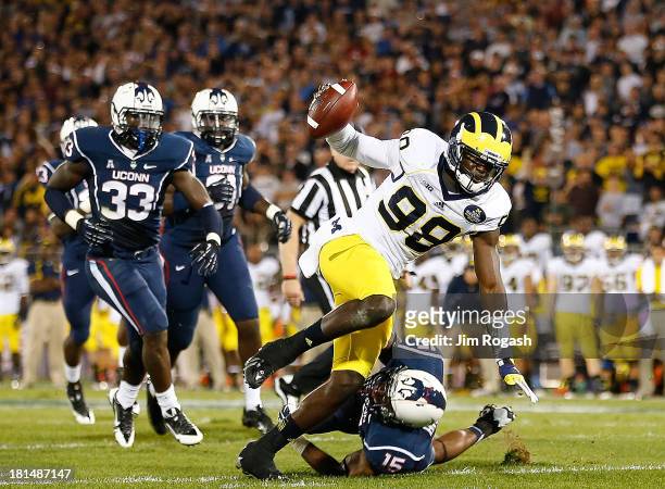 Devin Gardner of the Michigan Wolverines runs the ball in for a touchdown during a game with the Connecticut Huskies at Rentschler Field on September...