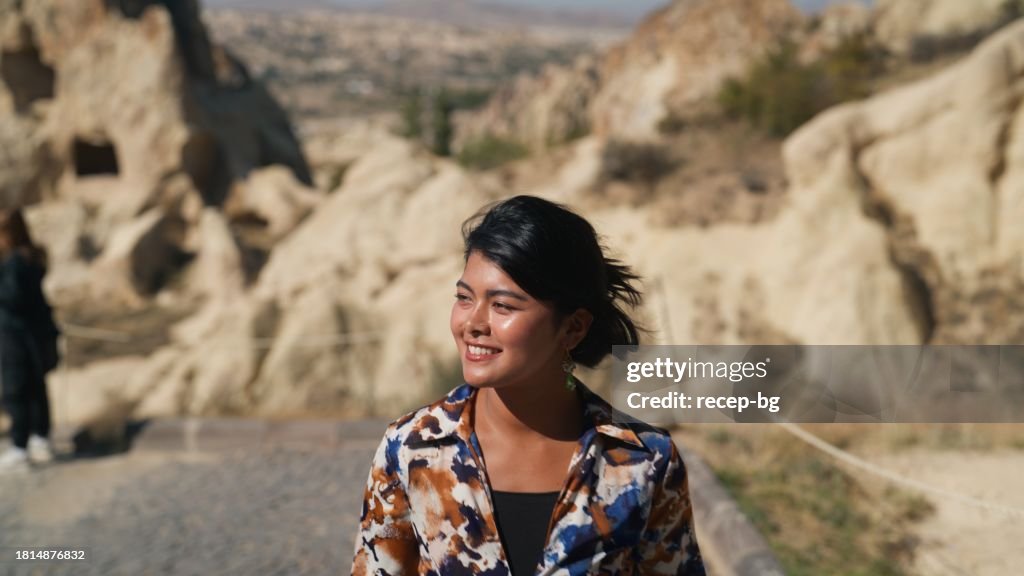Multiracial beautiful young female tourist hiking in nature in Cappadocia in Türkiye Turkey