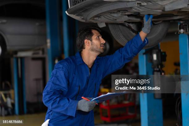 automotive technicians at the service station - machine part stock pictures, royalty-free photos & images