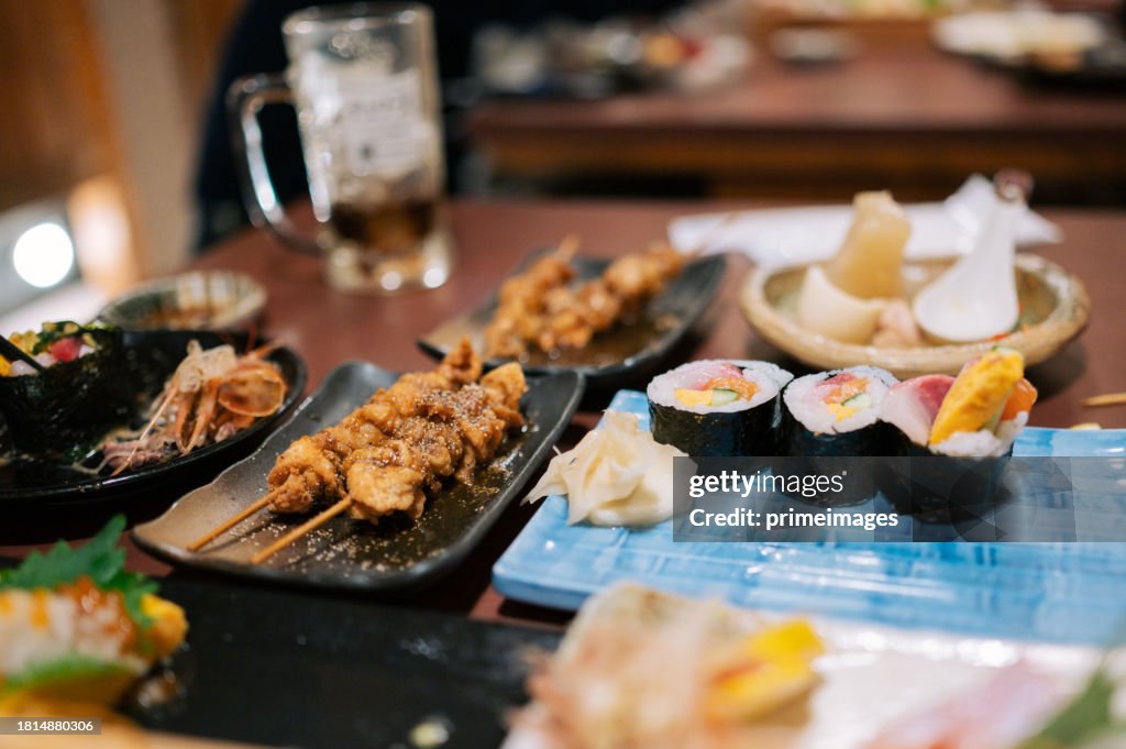 Group of friend dinning Sushi with Beer izakaya style japanese style in japanese restaurant