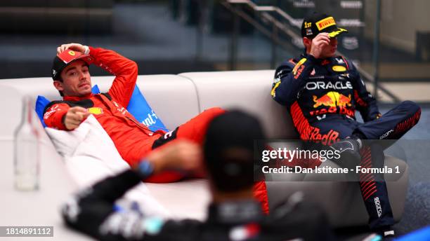 Second placed Charles Leclerc of Monaco and Ferrari talks to Third placed George Russell of Great Britain and Mercedes in the cool down room during...