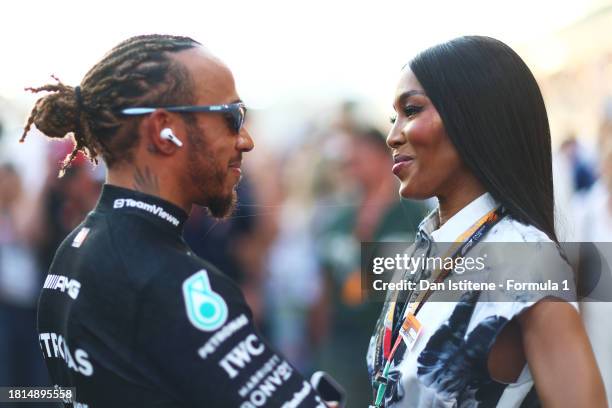 Lewis Hamilton of Great Britain and Mercedes talks to Naomi Campbell on the grid prior to the F1 Grand Prix of Abu Dhabi at Yas Marina Circuit on...