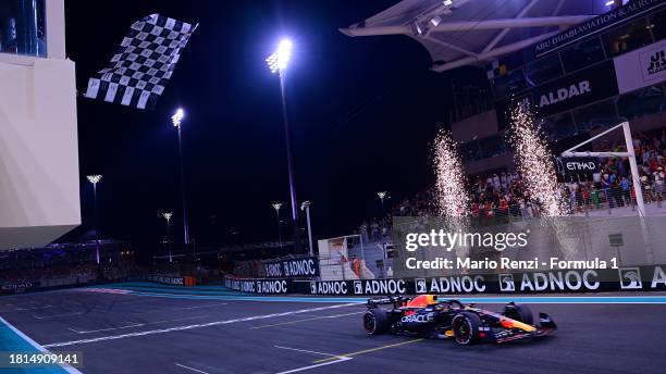 Race winner Max Verstappen of the Netherlands driving the Oracle Red Bull Racing RB19 takes the chequered flag during the F1 Grand Prix of Abu Dhabi...