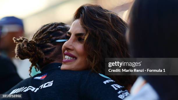 Lewis Hamilton of Great Britain and Mercedes embraces Priyanka Chopra on the grid prior to the F1 Grand Prix of Abu Dhabi at Yas Marina Circuit on...