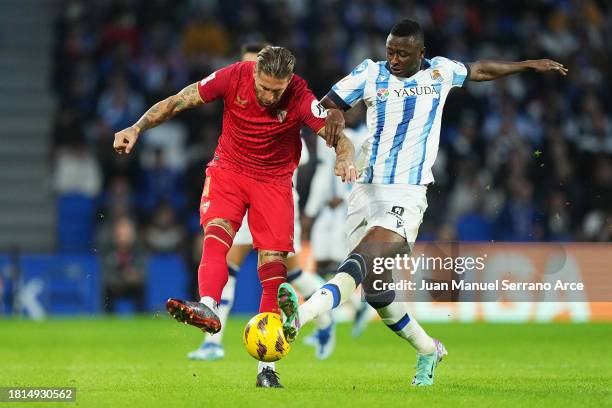 Sergio Ramos of Sevilla FC is challenged by Umar Sadiq of Real Sociedad during the LaLiga EA Sports match between Real Sociedad and Sevilla FC at...