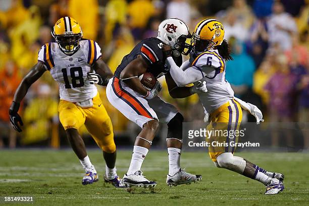 Ricardo Louis of the Auburn Tigers is tackled by Craig Loston of the LSU Tigers at Tiger Stadium on September 21, 2013 in Baton Rouge, Louisiana.