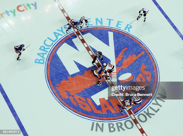 The New York Islanders and the New Jersey Devils drop the opening puck during a preseason game at the Barclays Center on September 21, 2013 in...