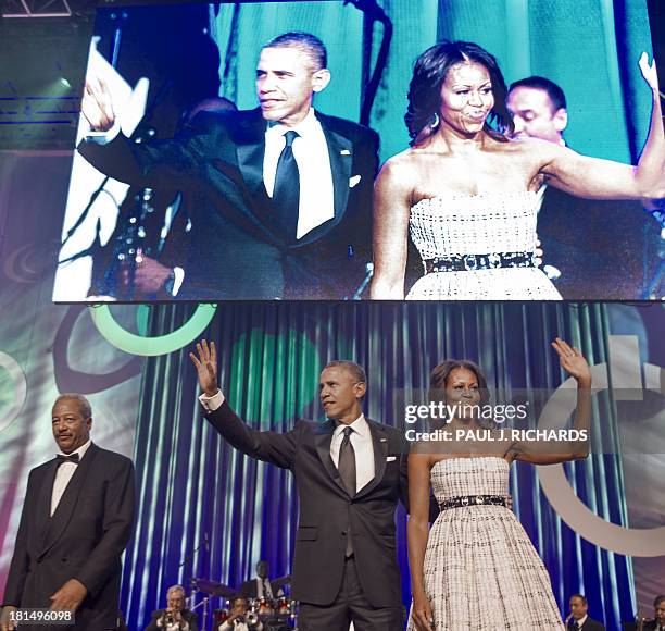 President Barack Obama and First Lady Michelle Obama wave as they attend the The Congressional Black Caucus Foundation, Inc. Annual Phoenix Awards...