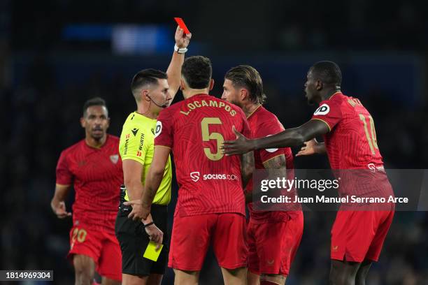 Referee Ortiz Arias shows a red card to Sergio Ramos of Sevilla FC during the LaLiga EA Sports match between Real Sociedad and Sevilla FC at Reale...