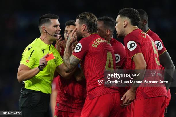 Referee Ortiz Arias shows a red card to Sergio Ramos of Sevilla FC during the LaLiga EA Sports match between Real Sociedad and Sevilla FC at Reale...
