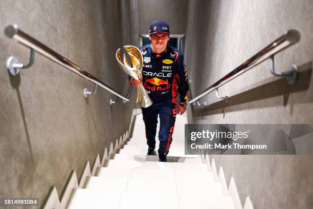 Race winner Max Verstappen of the Netherlands and Oracle Red Bull Racing walks with his trophy in the Paddock after the F1 Grand Prix of Abu Dhabi at...